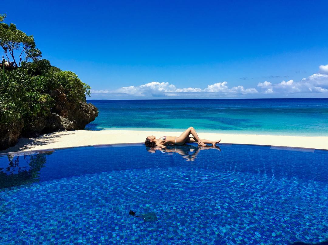 Vanessa Rallonza: Graceful Poolside Repose by Swimming Expanse