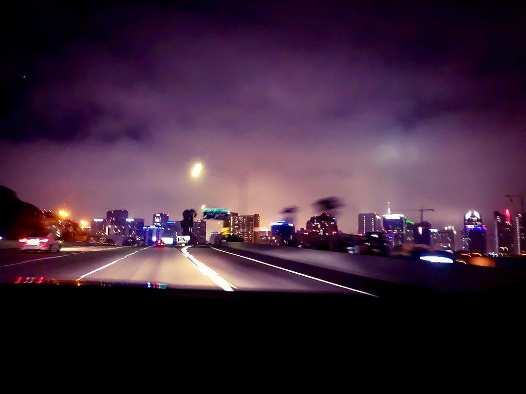 Vanessa Rallonza: Mesmerizing Nightscape, Sleek Vehicle Glides on Illuminated Highway