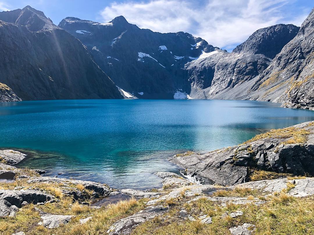 Vanessa Rallonza: Tranquil Mountainside Lake Reflection