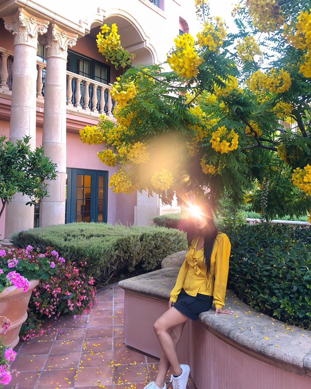 Vanessa Rallonza: Graceful Woman Amidst Blooming Flowers on Stonewall
