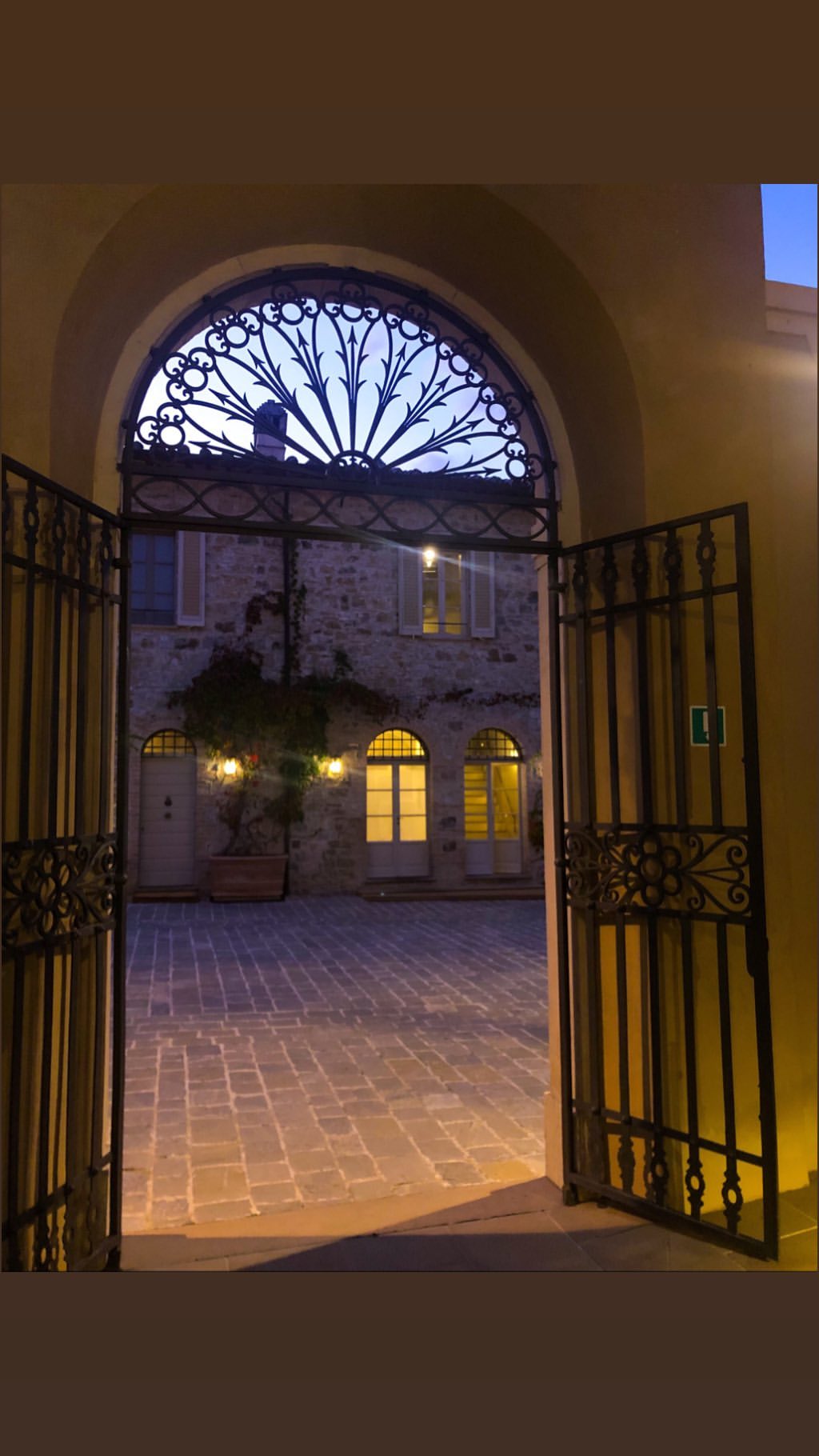 Vanessa Rallonza: Enchanting Gated Archway Under Warm Golden Glow