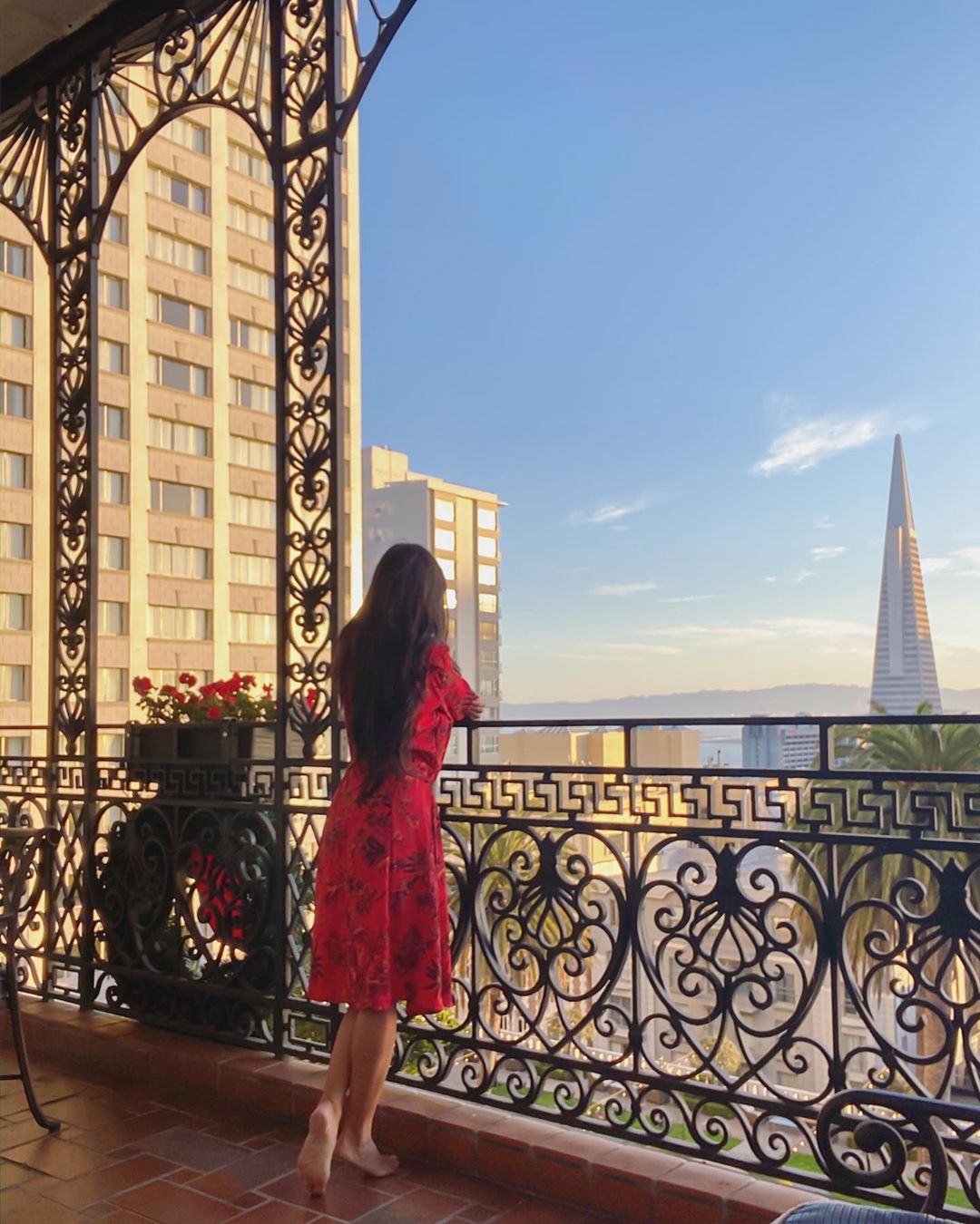 Vanessa Rallonza: Captivating Red-Draped Elegance at Balcony Edge