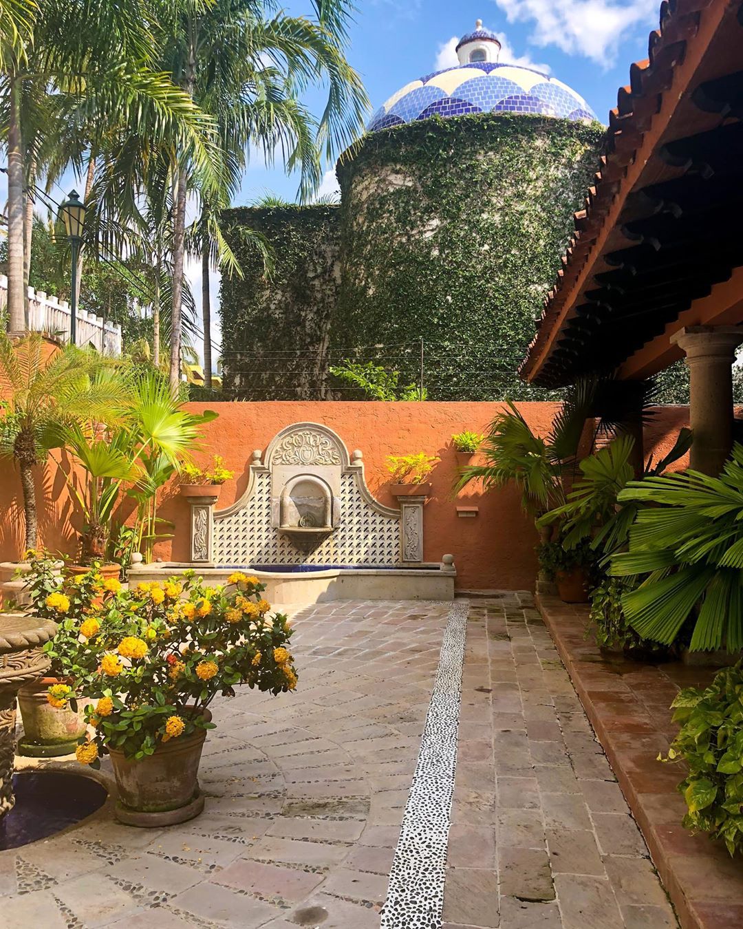 Vanessa Rallonza's Serene Courtyard with Tranquil Fountain and Lush Potted Plants