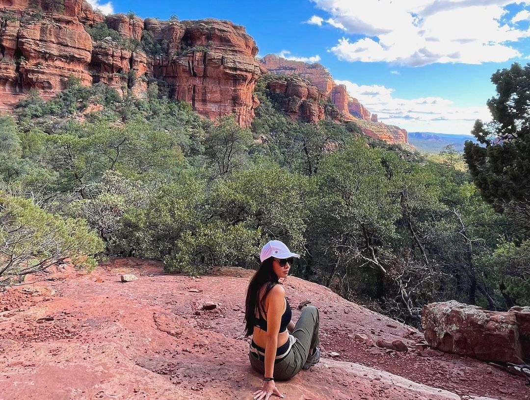 Vanessa Rallonza's Elegant Vista: Woman Perched on Weathered Rock